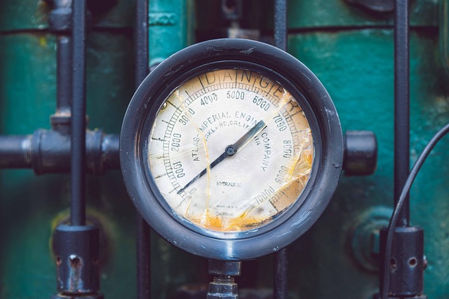 close-up of tire pressure gauge deflating winter tire to storage pressure level