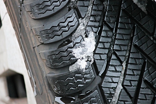 close-up of hand writing position markers on winter tire sidewall with chalk